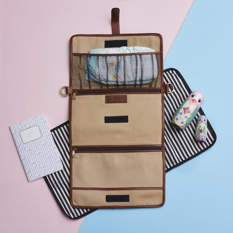 Brown and tan leather baby changing bag with waterproof mat