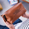 Anniversary leather wash bag with song lyrics embossed