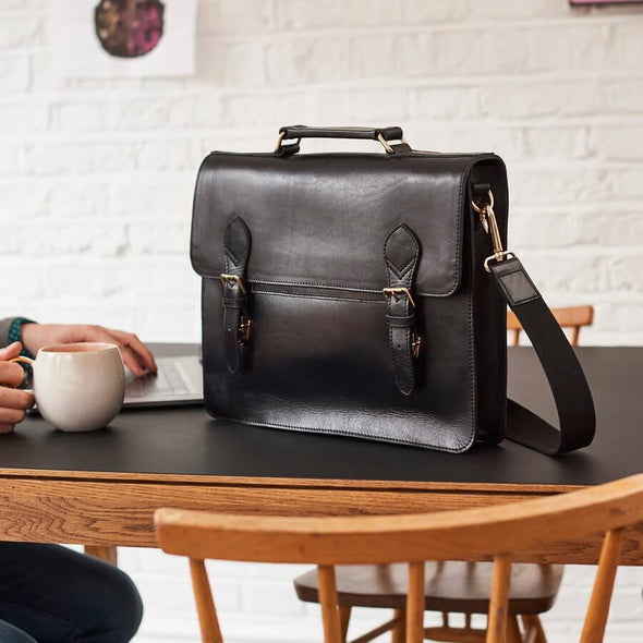 Briefcase Black leather laptop bag on table