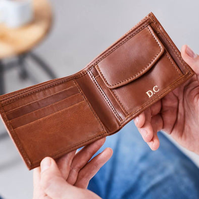 Tan leather wallet with coin section open
