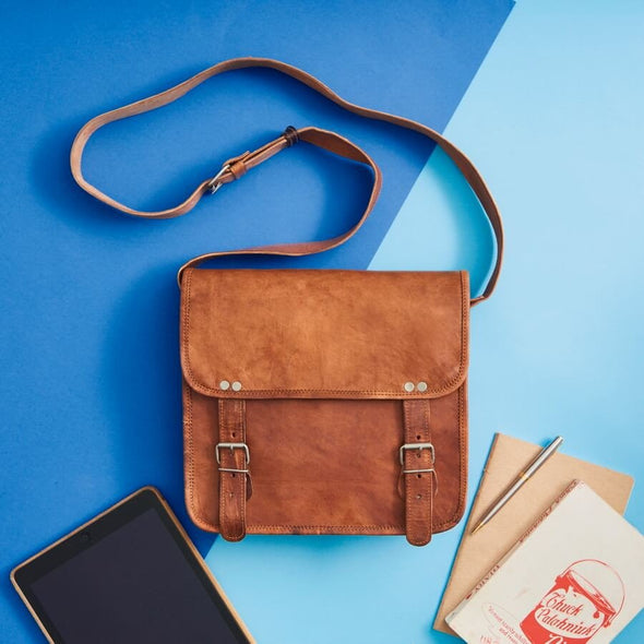 Mens leather satchel styled shot in tan vintage leather