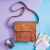Styled tan leather satchel with shoulder strap