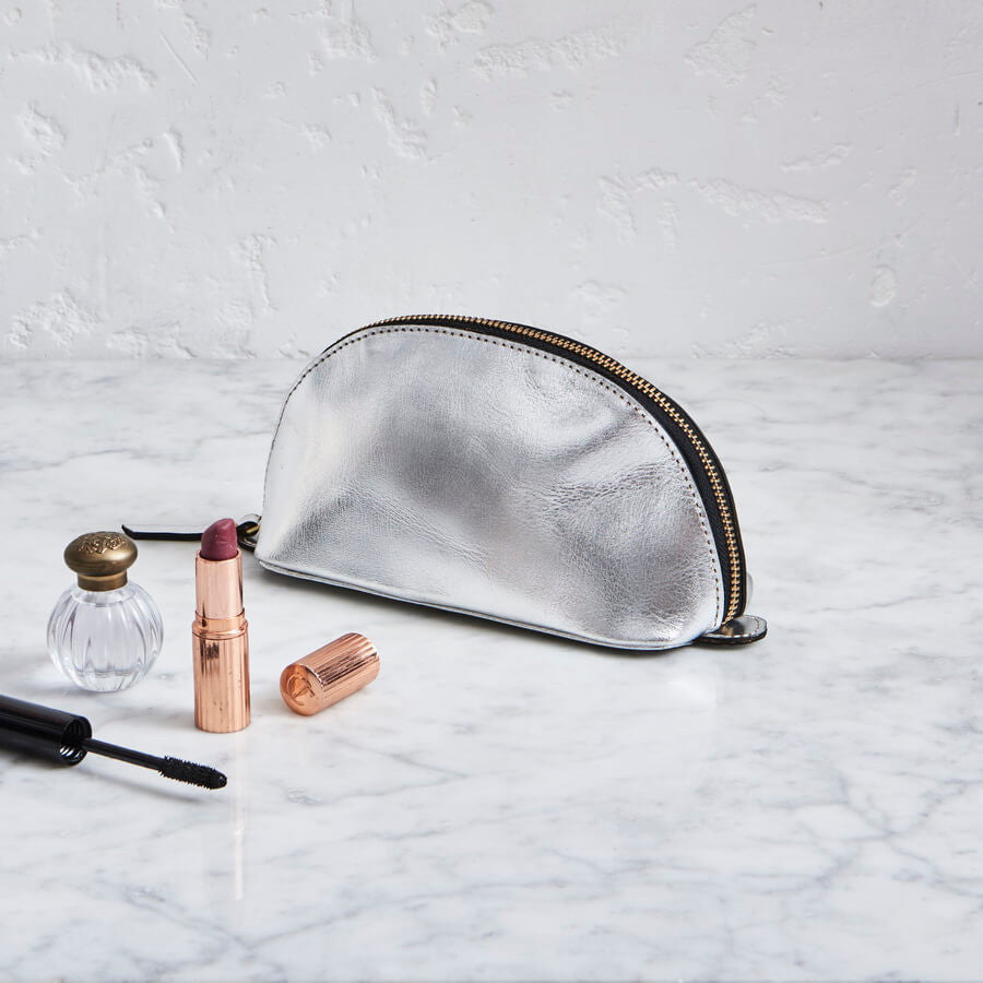 Metalic silver makeup and was bag in leather