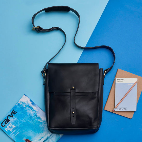 Black leather messenger bag with shoulder strap